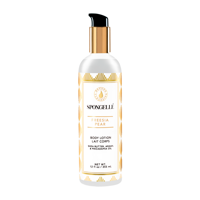 A white bottle of Spongellé - Freesia Pear Body Lotion, with golden accents and a black pump dispenser. The product contains shea butter and argan oil, ideal for dry skin.