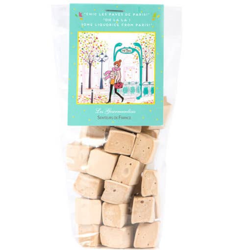 A package of Senteurs De France Soft Vanilla-Liquorice Squares with a colorful illustrated label showing a person walking with a dog under blooming trees, titled "les nougats de Paris" and described as "tender vanilla".