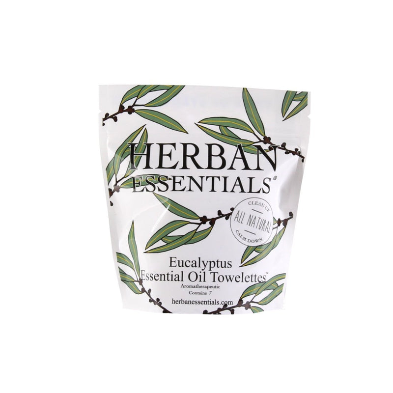A packet of Herban Essentials Essential Oil Towelettes - Eucalyptus Mini-Bags with a leafy design, emphasizing its all-natural, aromatherapeutic and decongesting qualities.