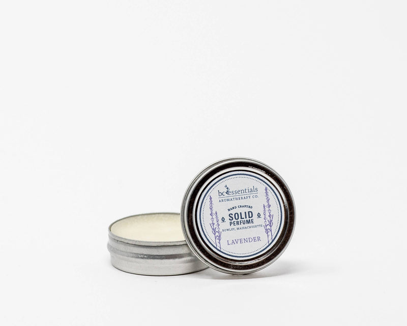 A small open tin of BC Essentials - Lavender Solid Perfume, displayed against a white background, showcasing the product inside the container.