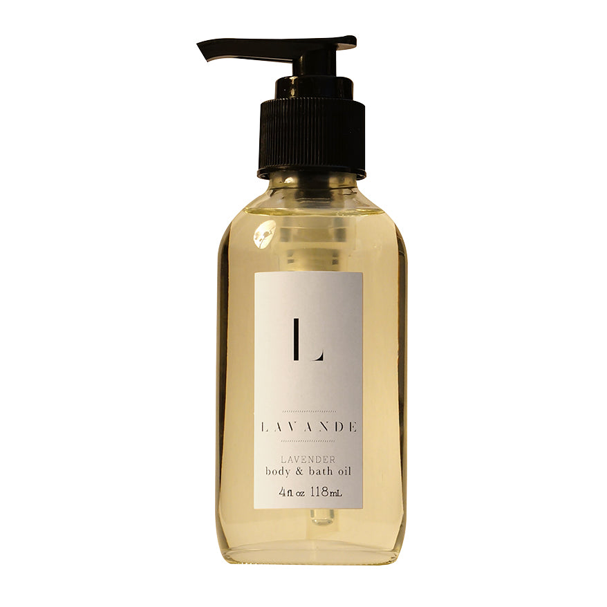 A clear bottle with a black pump dispenser, labeled "Lavande - Lavender Body & Bath Oil 4oz" featuring lavender essential oil and sweet almond oil, isolated on a white background.
