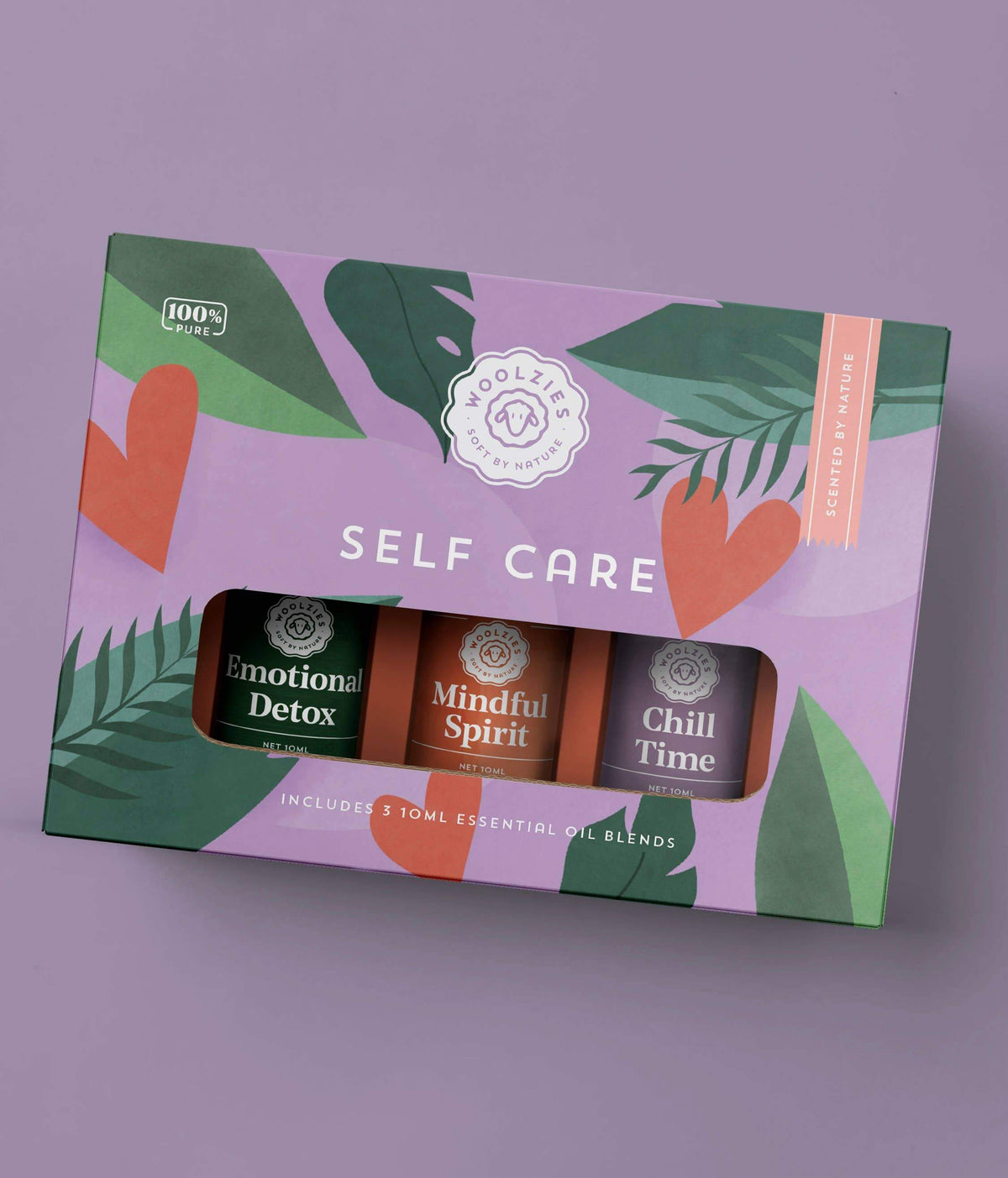 Product packaging of Woolzies The Self Care Collection essential oil blends featuring three types named emotional detox, mindful spirit, and chill time. The box has a green and purple design with leaf motifs.