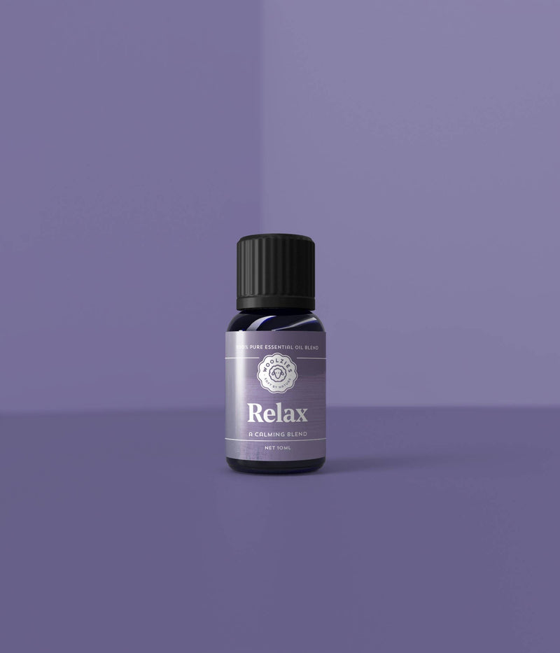 A small bottle labeled "Woolzies Relax Blend 10ml" placed on a purple surface against a matching purple background, emphasizing its soothing and minimalistic design.