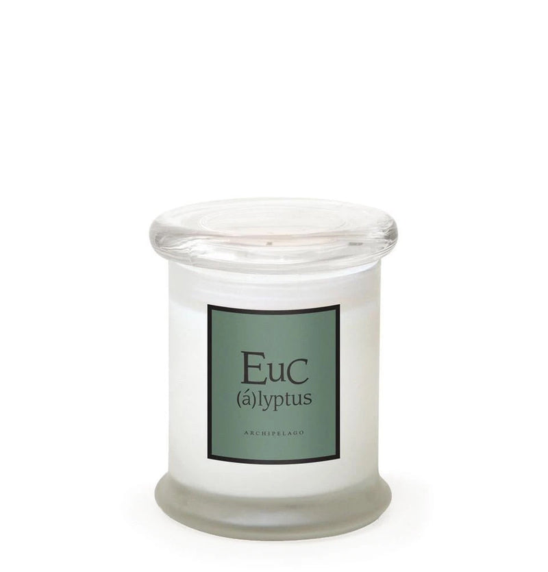 A Archipelago Botanicals candle with the label "Eucalyptus Leaf" on a white background, featuring a snug-fitting glass lid and pale wax inside.