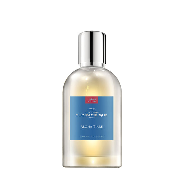 A clear glass perfume bottle labeled "Comptoir Sud Pacifique Paris Aloha Tiare" with a silver cap, showcasing a gradient yellow to clear liquid within.