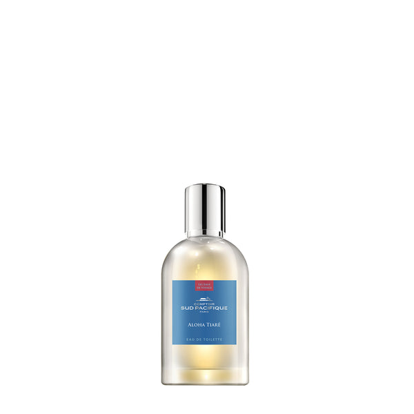 A transparent bottle of Comptoir Sud Pacifique Paris "Aloha Tiare" eau de toilette featuring Monoi on a white background, with product details clearly visible on the label.