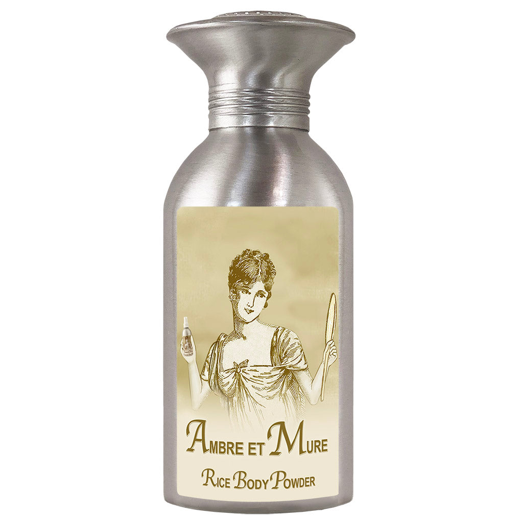 Vintage-looking La Bouquetiere body powder container labeled "La Bouquetiere Ambre et Mure Rice Powder" with an illustration of a classical woman holding a mirror and brush.