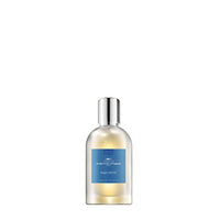A transparent perfume bottle labeled "Comptoir Sud Pacifique Paris Aqua Motu EDT" with marine notes against a white background. The liquid inside the bottle is yellow.