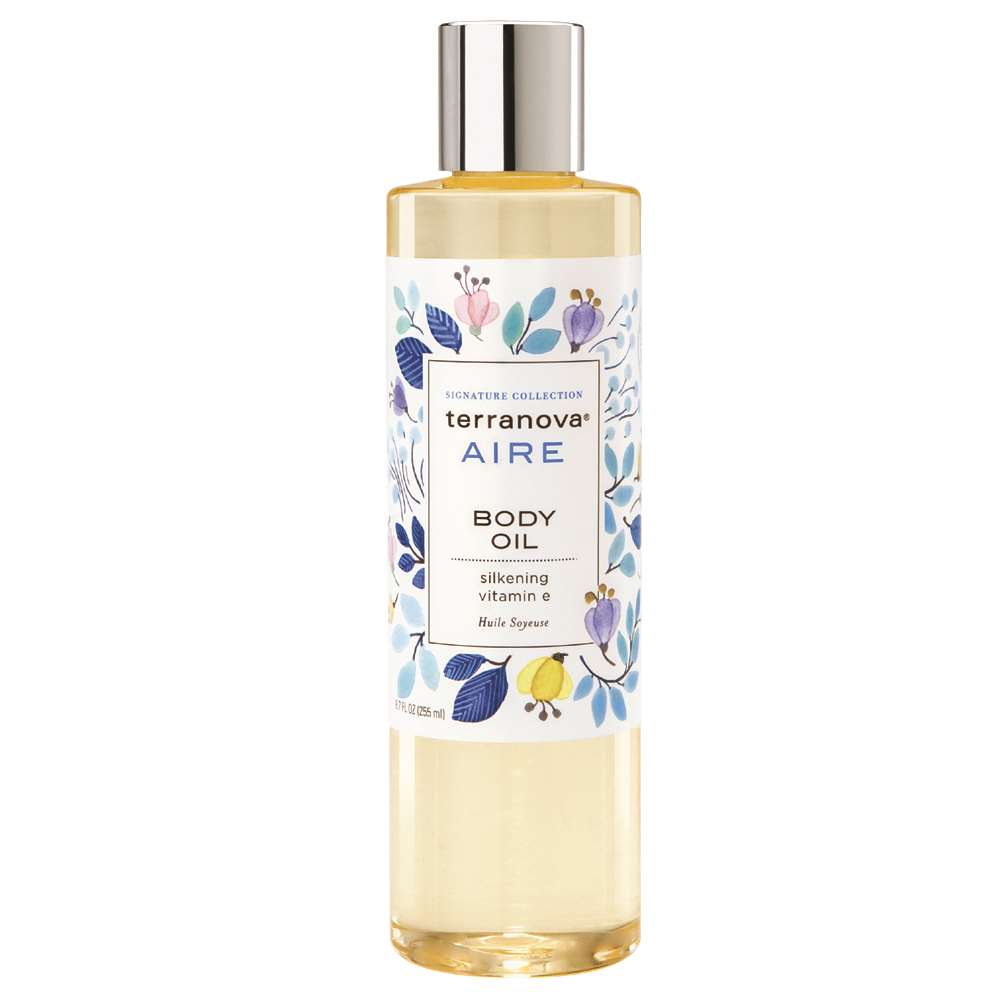 A bottle of Terra Nova Aire body oil with a floral and bird design on the label. The container is tall and cylindrical with a golden cap, containing luxurious oil ideal for moisturizing.