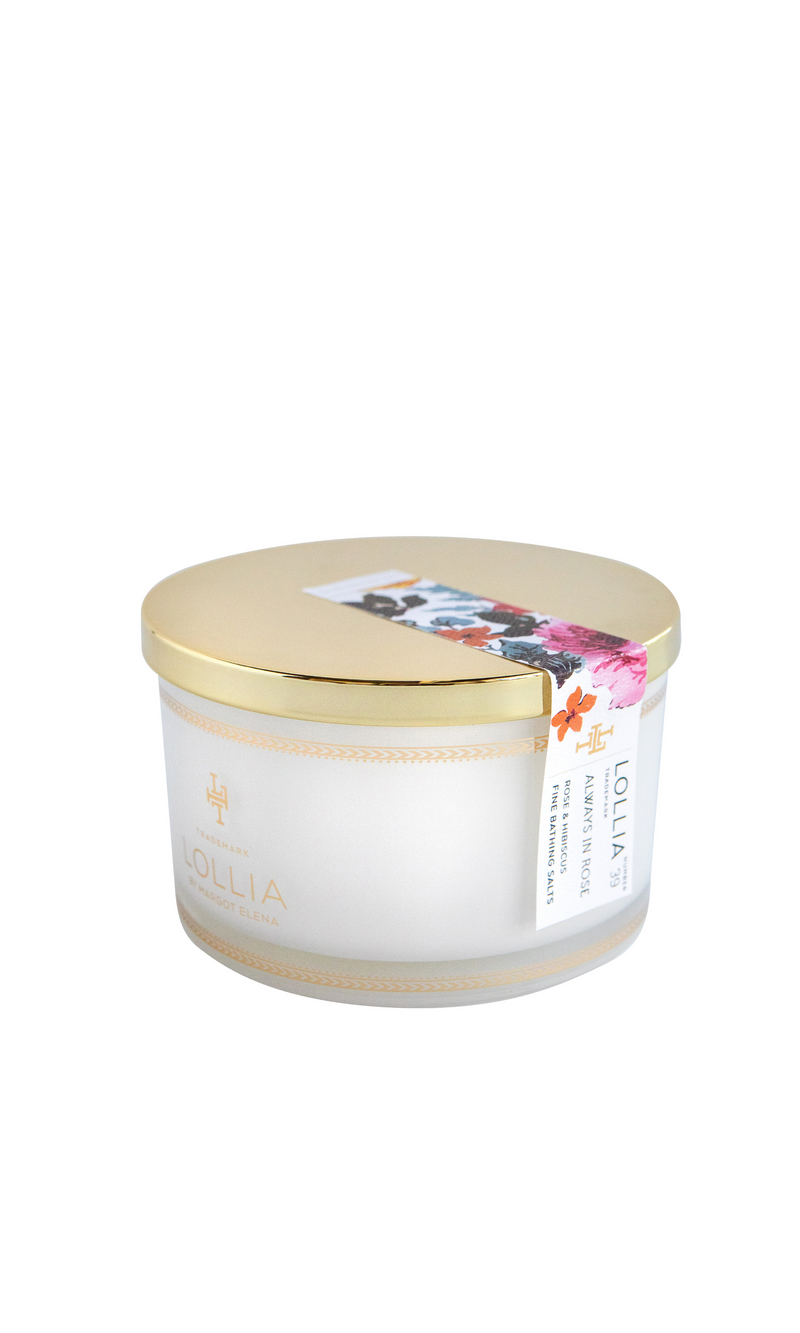 A cylindrical container of Margot Elena Lollia Always in Rose Fine Bathing Salts with a gold lid, featuring colorful floral artwork on the label.