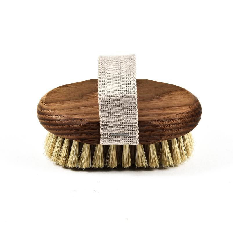 A round wooden Andrée Jardin Tradition Ash Wood Massage Brush with natural bristles and a white strap across the top, isolated on a white background.