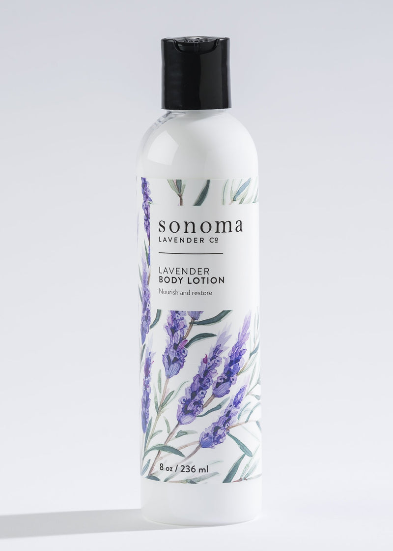 White bottle of Sonoma Lavender lavender body lotion with mango seed butter displayed against a light gray background, featuring a design with purple lavender flowers.