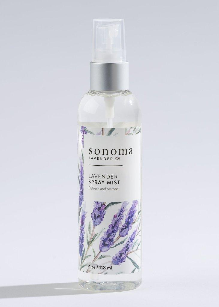 A clear bottle of Sonoma Lavender lavender spray mist, featuring floral designs, against a light grey background. This spray refreshes and soothes, perfect for scenting linens.