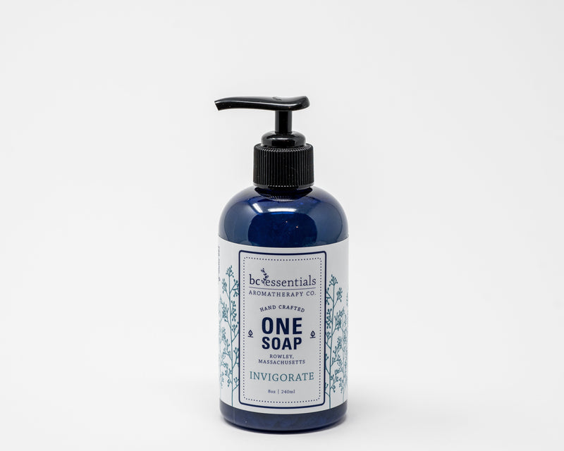 A blue glass bottle with a black pump, labeled "BC Essentials - Invigorate One Soap" by BC Essentials, on a plain white background.