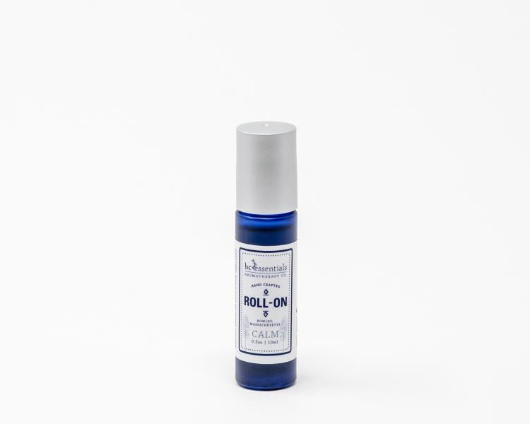 A BC Essentials essential oil roll-on bottle labeled "Calm" designed to reduce anxiety, on a plain white background.