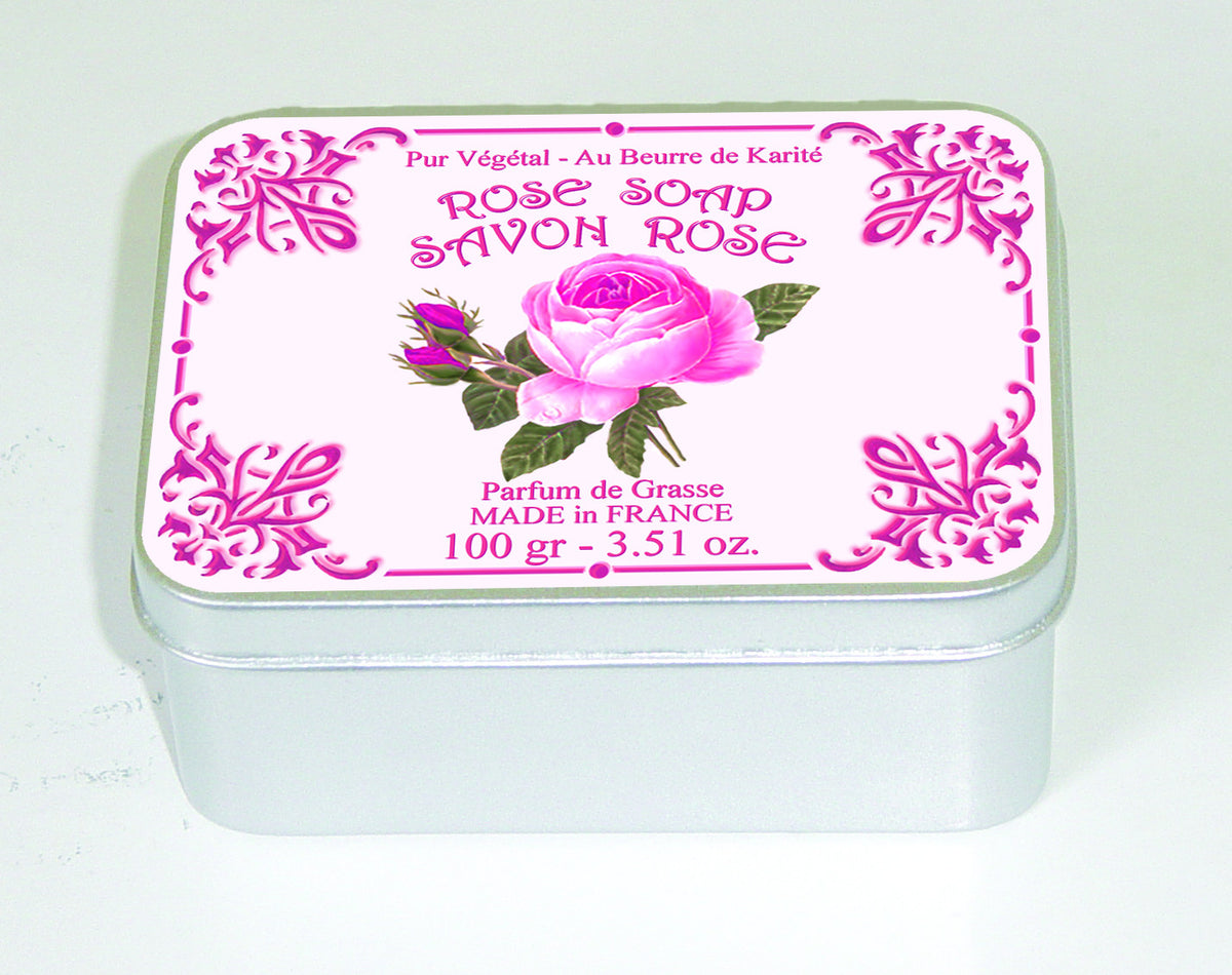 A decorative silver tin containing Le Blanc Rose 100gm Soap Tin, labeled in pink and white with a floral design and text in French, indicating the soap is made in France with shea butter.