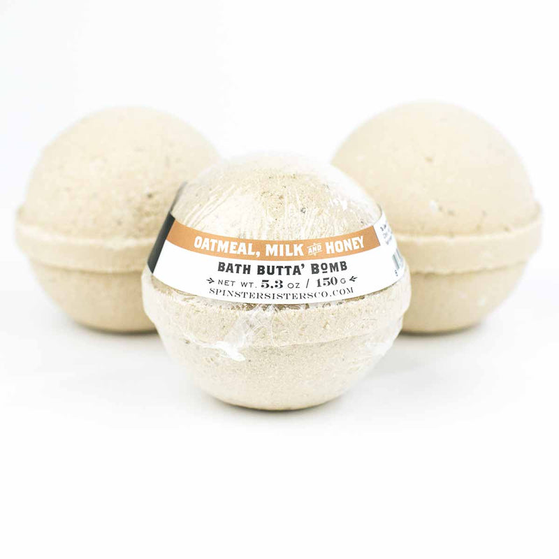 Three Spinster Sisters Bath Butta' Bombs - Oatmeal, Milk & Honey are displayed against a white background, each with a label around the center.