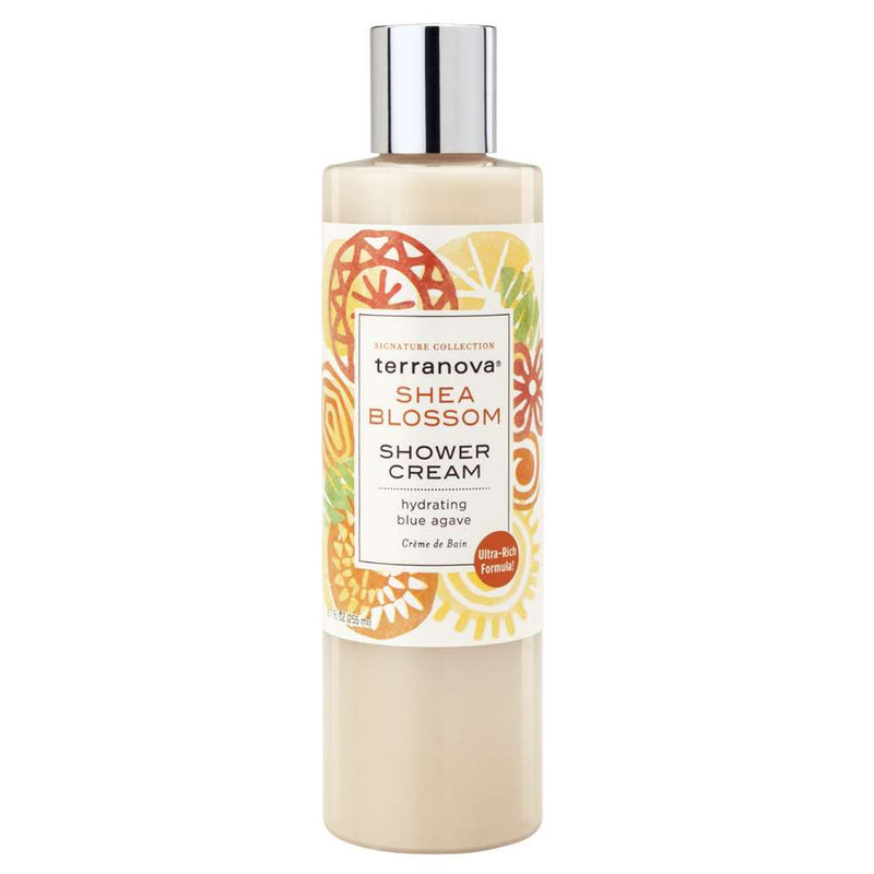 A bottle of Terra Nova Shea Blossom Shower Cream with Hydrating Blue Agave with an illustrated label featuring orange, yellow, and green floral designs, indicating its moisturizing and blue agave enriched formula.