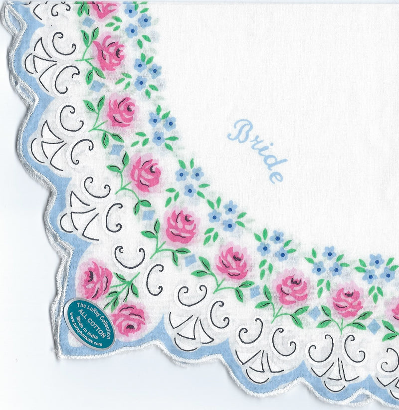 A white Vintage-Inspired Hanky with scalloped edges, detailed with pink roses and blue flowers, and the word "bride" embroidered in blue features a "something blue" sticker at the corner.