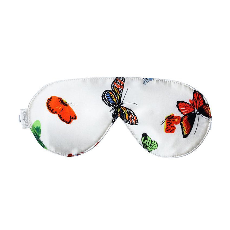 elizabeth W Silk Sleep Mask - Butterfly featuring a white silk background adorned with colorful butterflies in orange, red, and black hues.