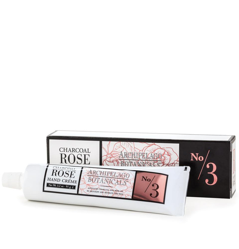 An Archipelago Botanicals Charcoal Rose Hand Creme in a charcoal rose scent, packaging displays intricate floral graphics, primarily in red and white colors with the text "Charcoal Rose Hand Creme" highlighted.