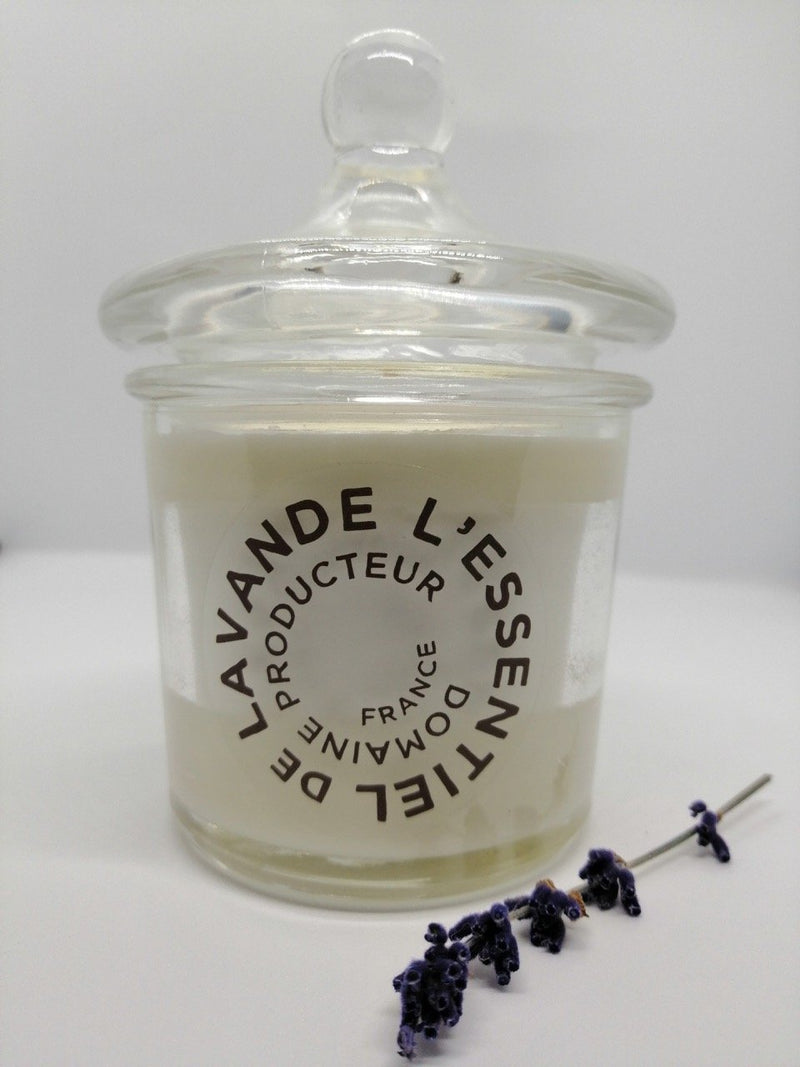 A l'Essential de lavande Scented Candle by Made in Provence with a label reading "lavande l'essentiel producteur de france" beside dried lavender sprigs, set against a white background.