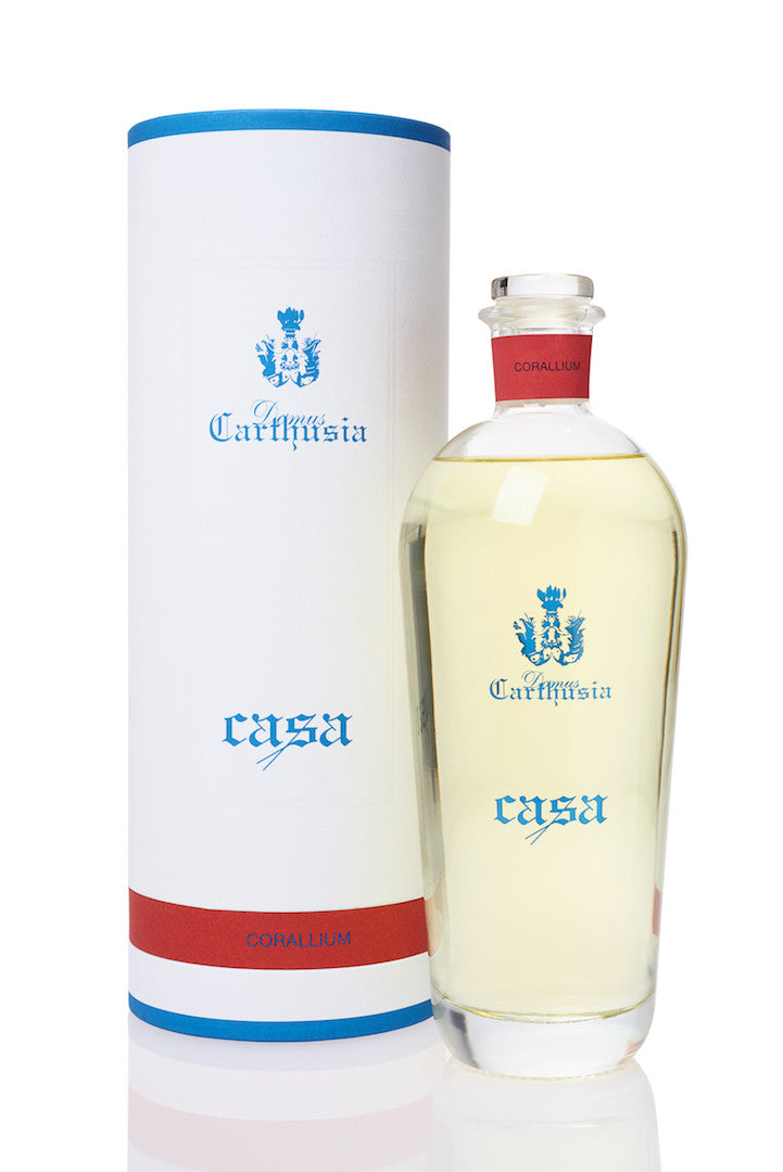A clear glass Carthusia Corallium Reed Diffuser & Refill with a white label featuring the word "Carthusia I Profumi de Capri" and "Fayal". Next to it is its matching tall cylindrical white packaging with blue accents.
