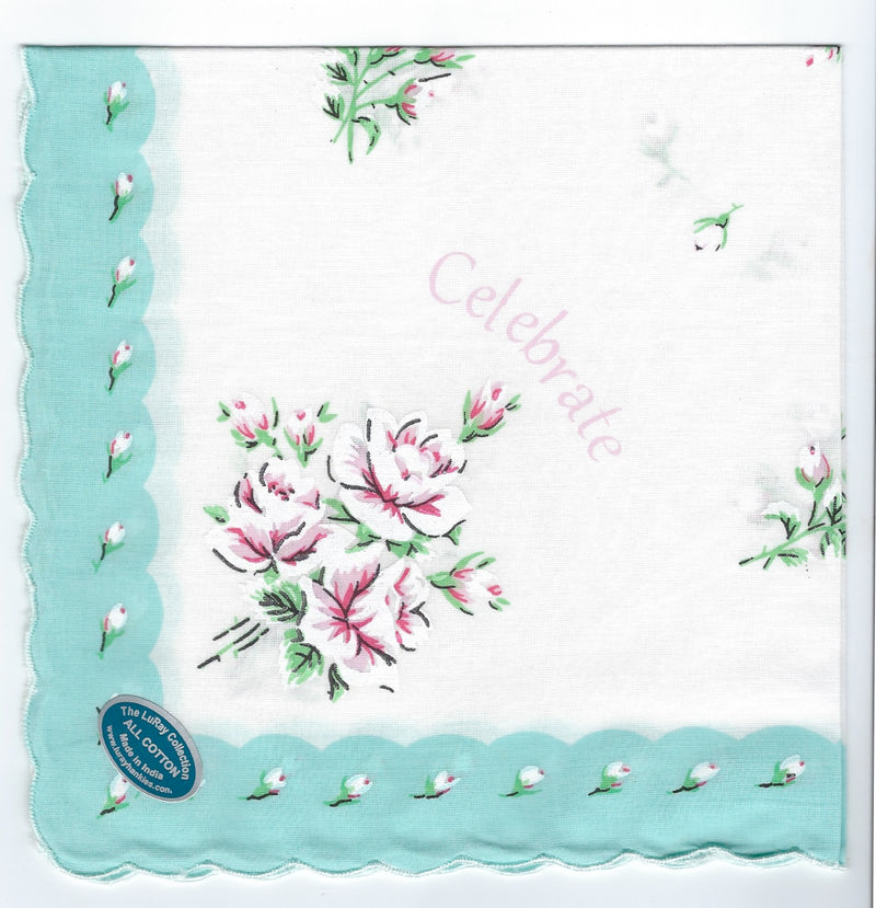 A decorative Vintage Inspired Hanky - Celebrate with scalloped teal edges featuring a floral design of pink and white flowers, and small green leaves; the word "celebrate" is central, and a blue seal at by Hankies ala Carte.