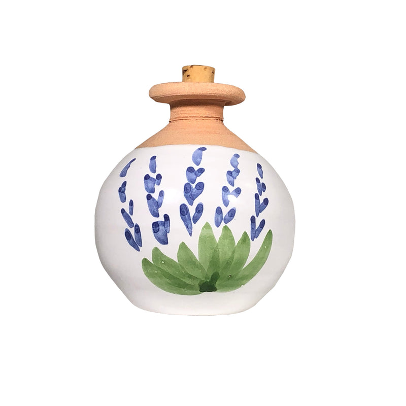 A round La Lavande ceramic diffuser with a wooden top, painted with blue floral patterns and green leaves, isolated on a white background.