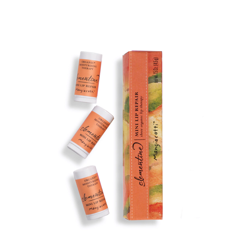Flat-lay of three Mangiacotti Clementine Mini Lip Repair tubes with various labels next to an orange, patterned Mangiacotti lip balm box on a white background. The product names and organic ingredients are visible on the items.