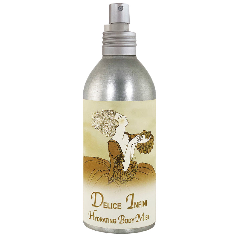 A cylindrical bottle of La Bouquetiere Delice Infini Body Mist with a metallic finish and a detailed illustration of a woman spraying alcohol-free mist on herself.
