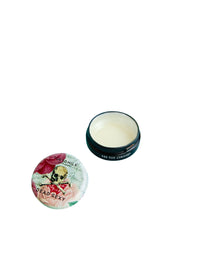 A jar of Margot Elena's TokyoMilk Dead Sexy conditioning lip balm, with the lid off to the side, revealing the creamy product inside, isolated on a white background.