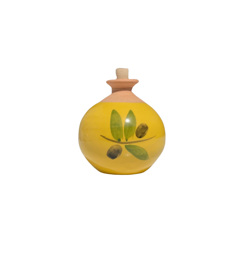 A La Lavande ceramic diffuser with a cork stopper, decorated with a simple green olive branch design, isolated on a white background.
