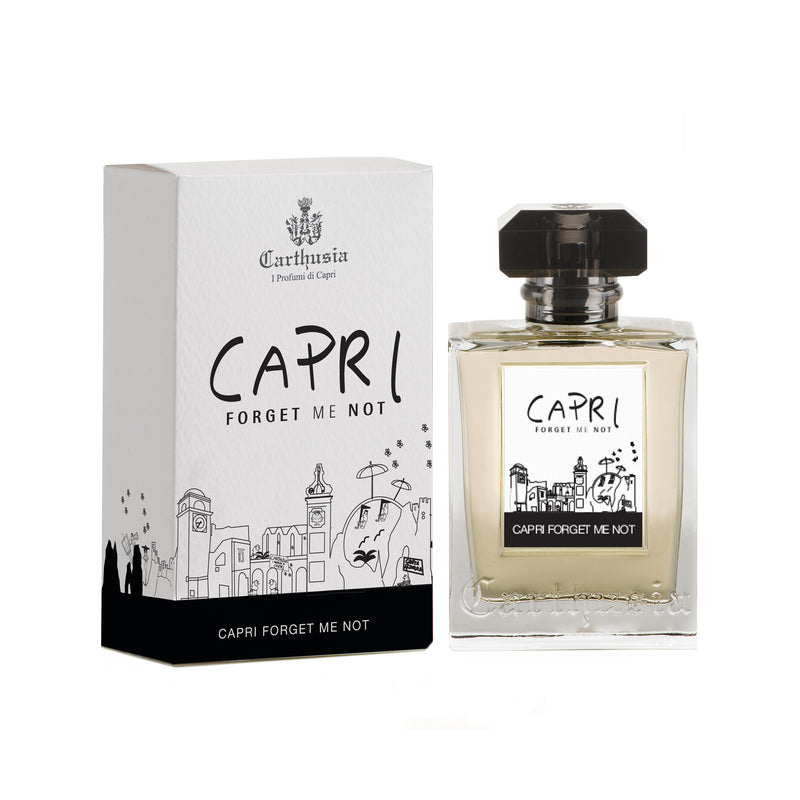 A bottle of Carthusia Capri Forget Me Not Eau de Parfum by Carthusia I Profumi de Capri next to its packaging. The packaging features a sketched illustration of Capri’s landscape. The perfume bottle is clear with a