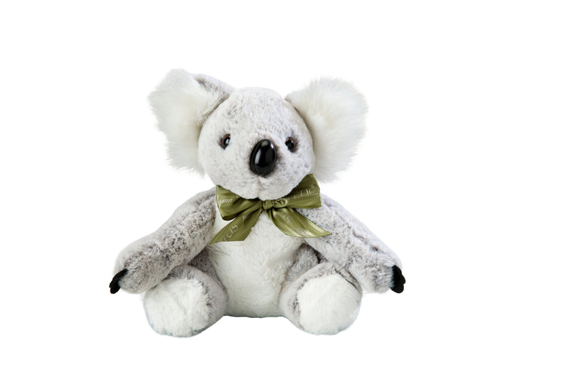 A hand-crafted Sonoma Lavender "Kaylee", the eucalyptus Koala plush toy with a green bow around its neck, sitting against a white background.