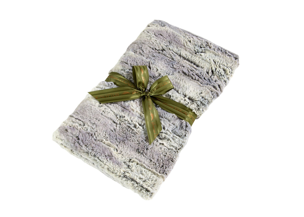 Plush gray and white SONOMA EUCALYPTUS SILVER FOX SPA BLANKIE neatly folded and tied with a shiny green ribbon, isolated on white background.