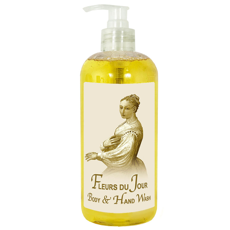 A transparent pump bottle of La Bouquetiere Fleurs du Jour Gentle Hand & Body Wash, labeled "fleurs du jour" with a classic illustration of a woman in period attire on the label, filled with yellow liquid.