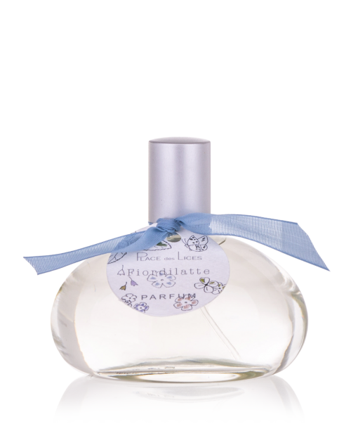 A clear Place des Lices Fiordilatte Eau de Parfum bottle with a spherical base and a short neck, adorned with a light blue ribbon and decorative label featuring elegant script and floral motifs, set against a white background. The label prominently includes the.