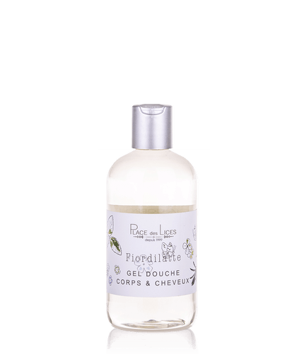Transparent bottle of Place des Lices Fiordilatte Hair & Body shower gel with a silver cap, labeled in French for body and hair use, set against a plain background. It contains delicately fragranced foam.