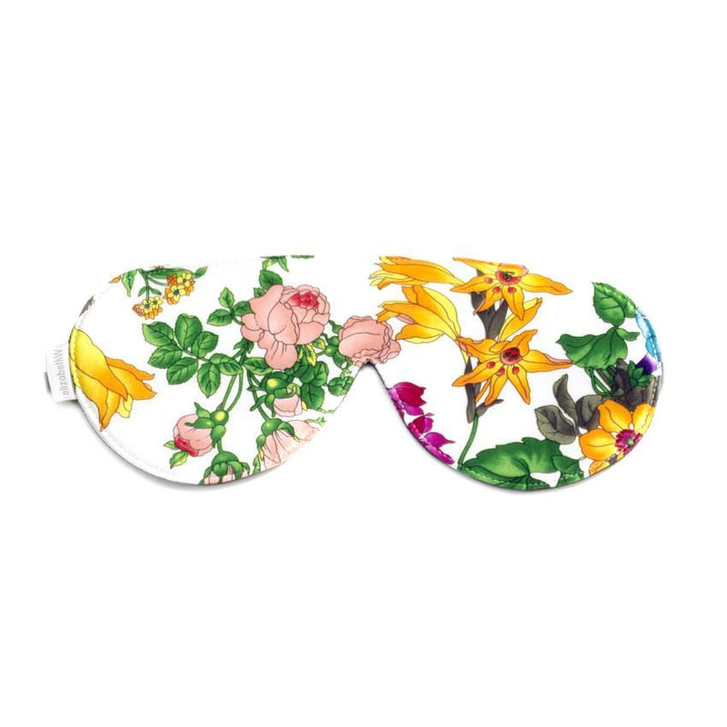 elizabeth W Silk Sleep Mask - Floral Blush with a light blocking, colorful floral pattern divided into two distinct parts, each featuring different flower varieties on a white background.
