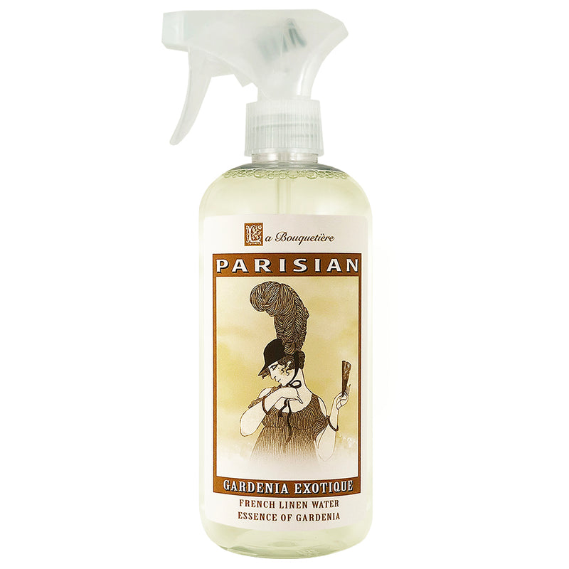 A spray bottle labeled "La Bouquetiere Gardenia Exotique Linen Water, essence of gardenia" featuring an illustration of a vintage style woman in a sophisticated outfit on the label, containing biodegradable ingredients.