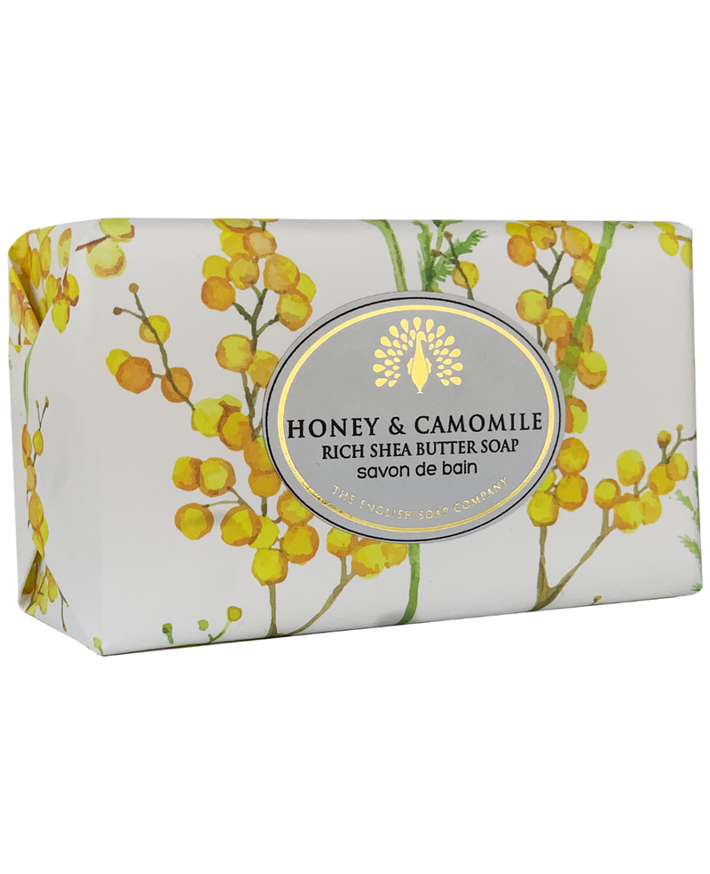 Rectangular soap package labeled "The English Soap Co. Honey & Camomile Vintage Italian Wrapped Soap" with a floral design featuring yellow blossoms.