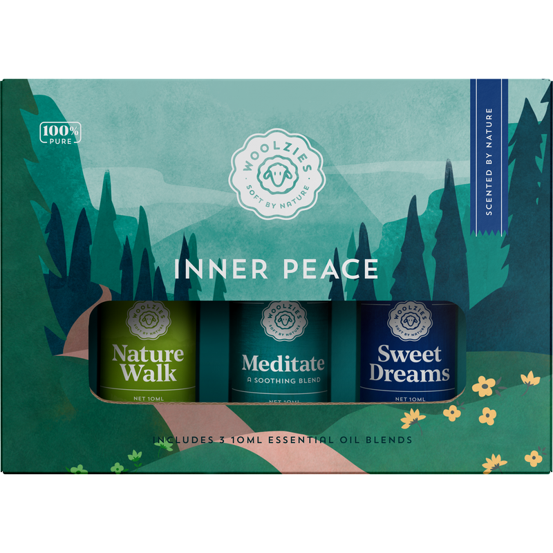 Packaging design for Woolzie's Inner Peace Set of 3 essential oils, made in India, featuring three blends: nature walk, meditate, and sweet dreams, with a serene forest-themed background.