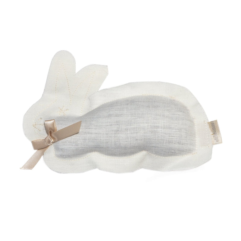 A ivory sleep mask with a contoured design, herbal aroma, and a decorative beige bow on the right side, displayed against a plain white background.