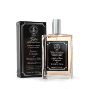 A bottle of Taylor of Old Bond Street Jermyn Street Alcohol-Free Cologne for Sensitive Skin next to its black packaging box, both labeled with elegant, vintage-style graphics and text. The bottle has a transparent design with a silver spray top.