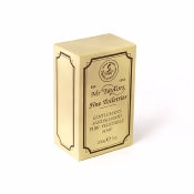 A gold-colored book-shaped tin with embossed detailing, featuring text that indicates it's related to "Taylor of Old Bond Street Sandalwood Pure Vegetable Soap - 200gm," noting it as bottled and distributed in Australia with a masculine scent.