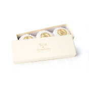A box of Taylor of Old Bond Street Sandalwood hand soaps with intricate gold detailing on the lids, presented against a clean, luxurious base.