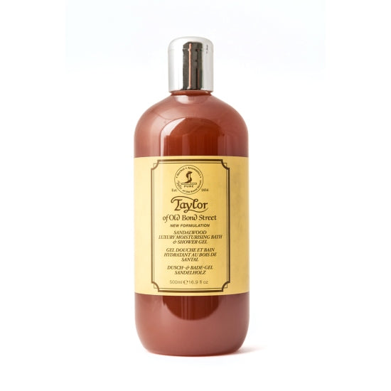Amber-colored Taylor of Old Bond Street Sandalwood Luxury Moisturizing Bath & Shower Gel bottle with a vintage-style label from "Taylor of Old Bond Street", against a white background. The label details the product and address in elegant font.