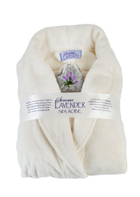 A plush white spa robe folded neatly with a label reading "Sonoma Lavender Ultra-luxe Plush Robe - Ivory" and a small sachet of lavender tucked into the fold.