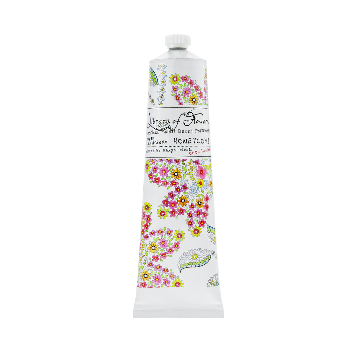 A tall, slender tube of Library of Flowers Honeycomb Hand Creme enriched with shea butter, decorated with a colorful floral and honeycomb pattern and elegant text detailing the Margot Elena brand and product scent.